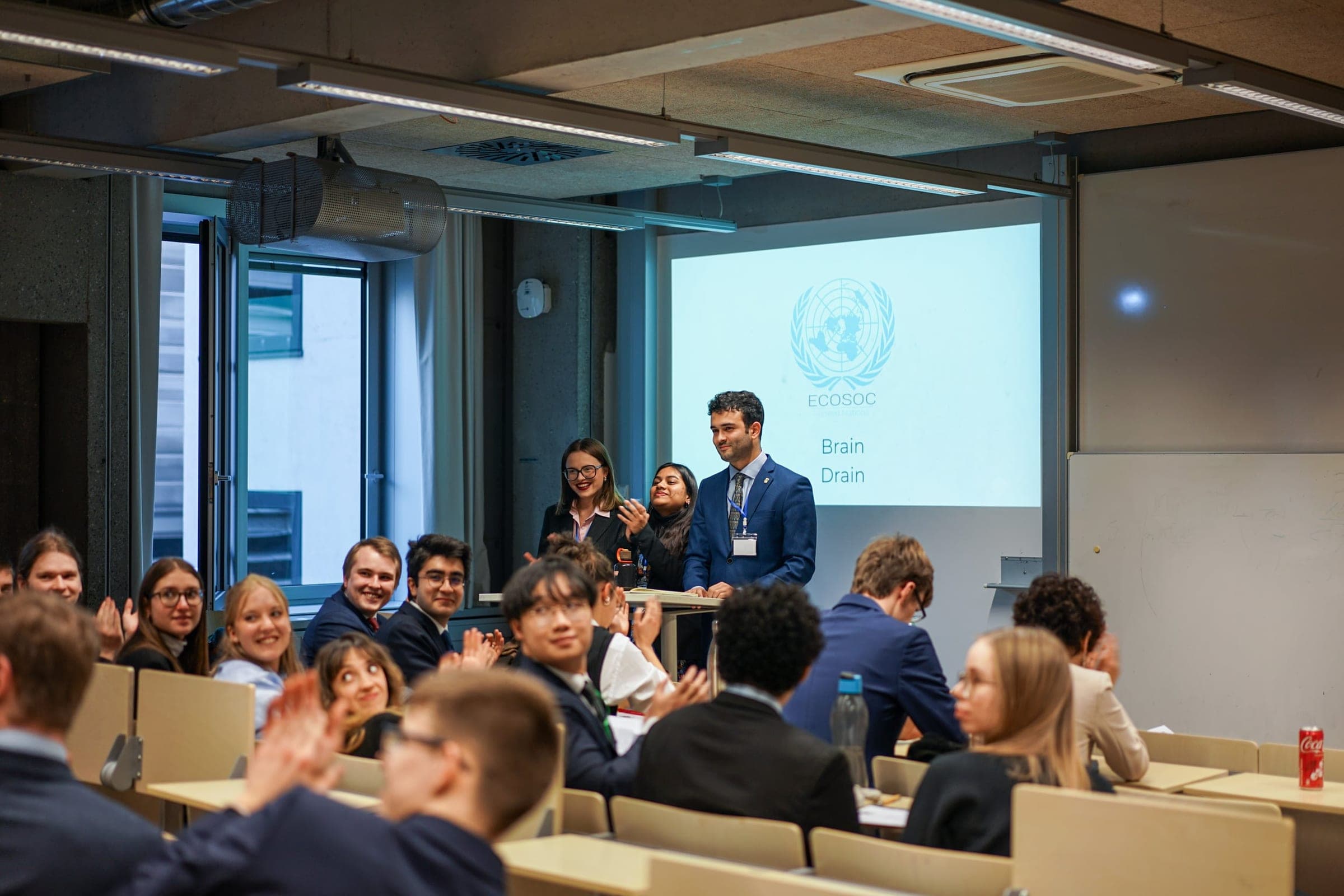 Delegates applauding in an ECOSOC committee session at the Munich Diplomacy Summit