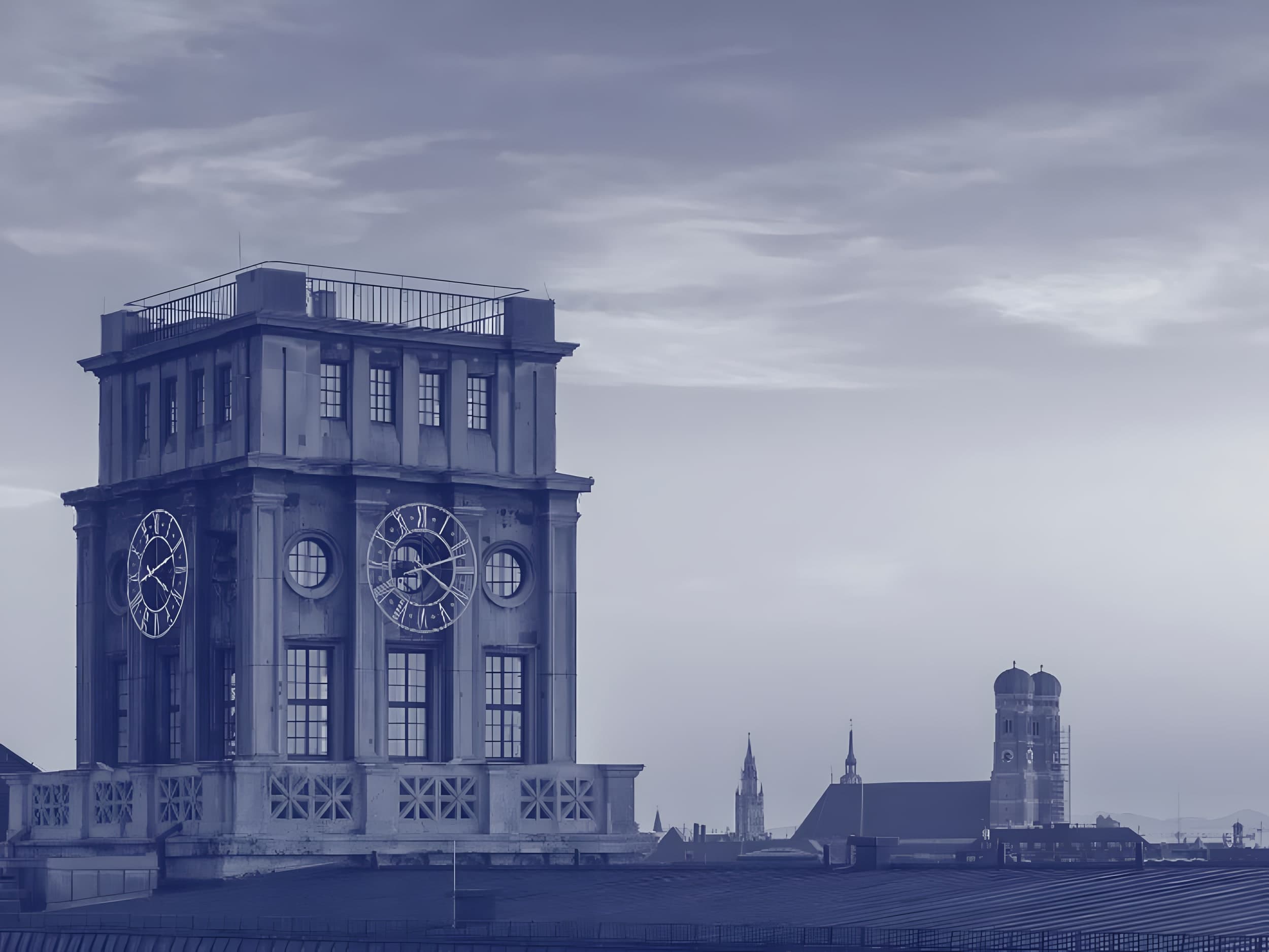 Clock tower of the TUM main building and the Munich skyline with the Frauenkirche